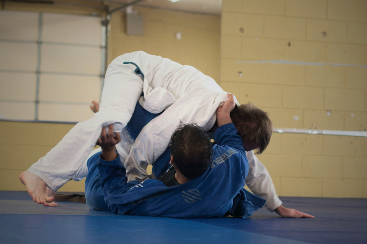 Two athletes grappling on a mat