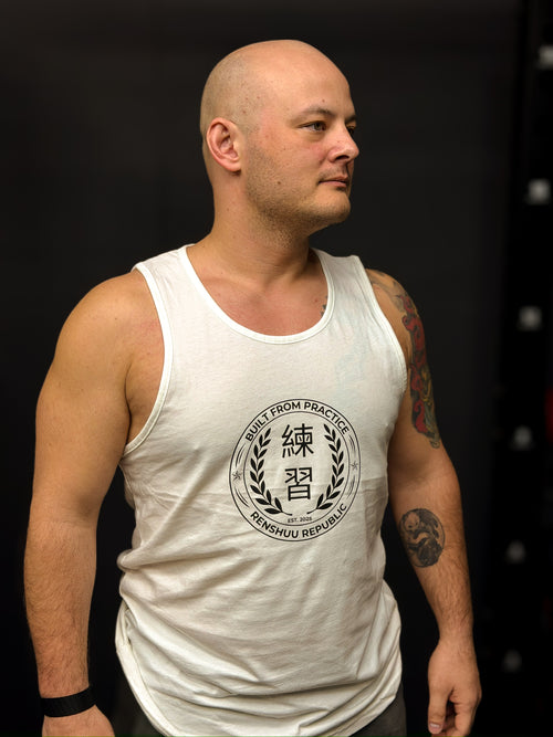 Man wearing a white tank top with a logo on a black background