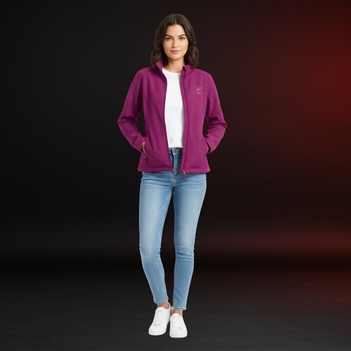 Woman wearing a purple jacket, white shirt, blue jeans, and white sneakers on a dark background