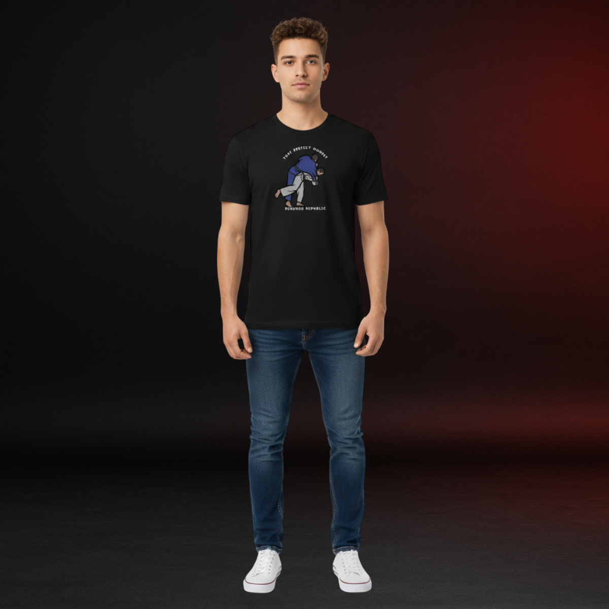 Person wearing a black t-shirt with a graphic design on a dark background