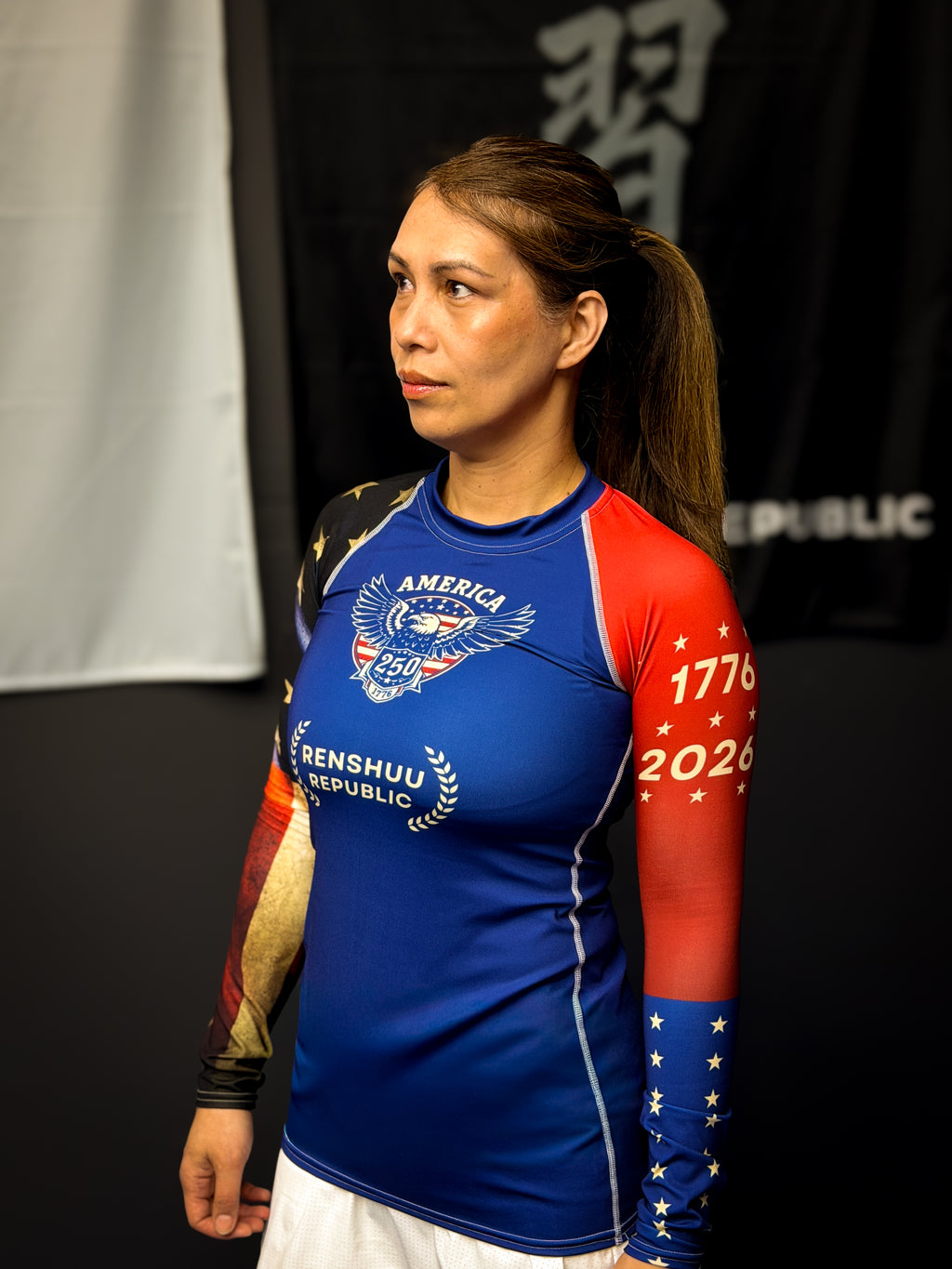 Person wearing a blue and red athletic shirt with visible branding