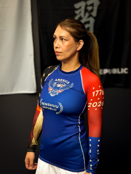 Person wearing a blue and red athletic shirt with visible branding