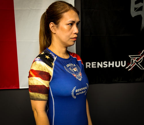 Person wearing a blue athletic shirt with Renshaw branding in front of a branded backdrop.