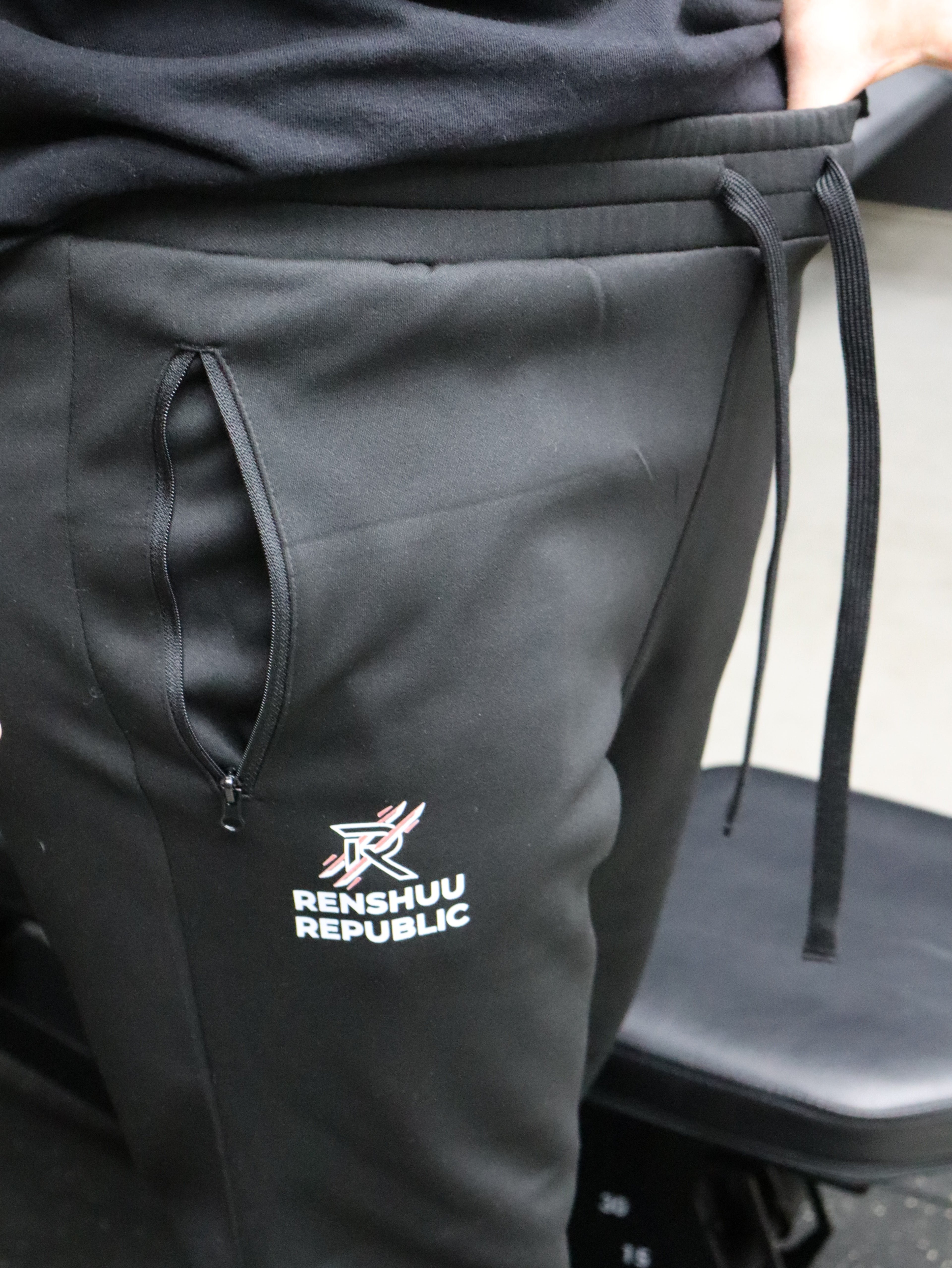 Black jacket with a visible brand logo on a mannequin