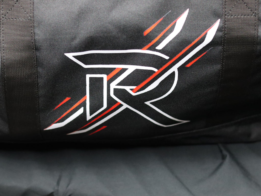 Black bag with a white and red logo on a gray surface
