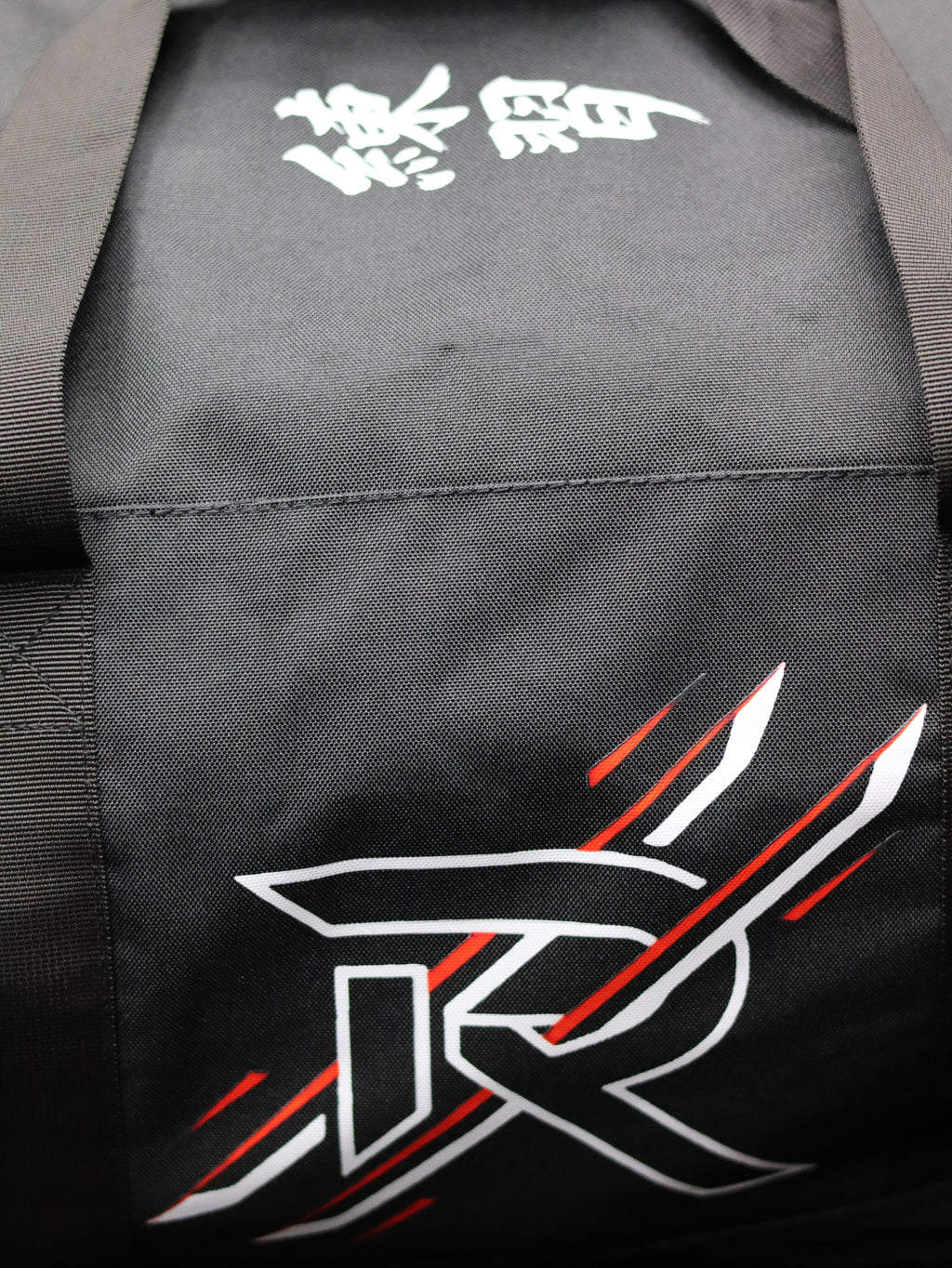 Black gi with white and red design on the back