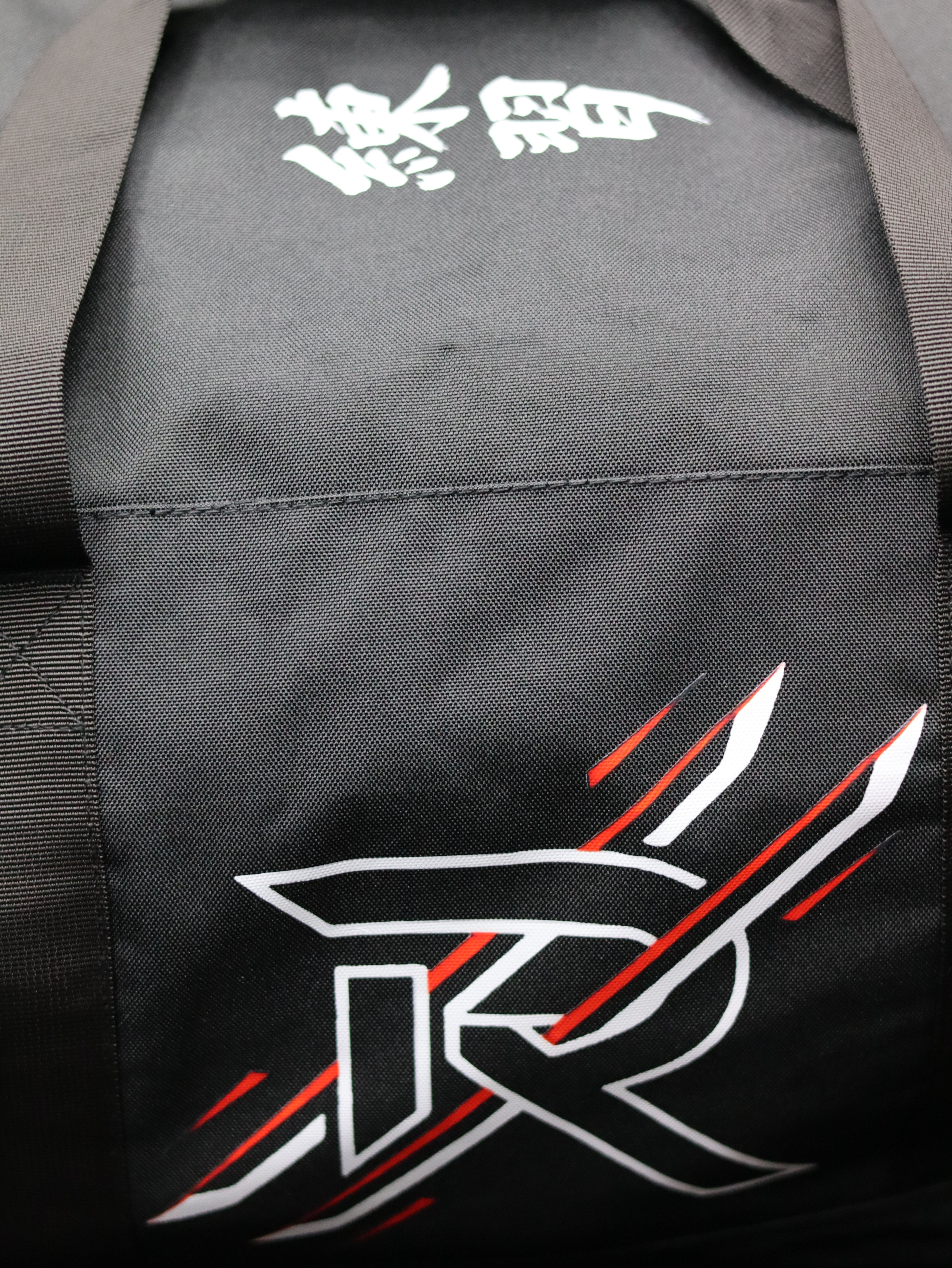 Black gi with white and red design on the back