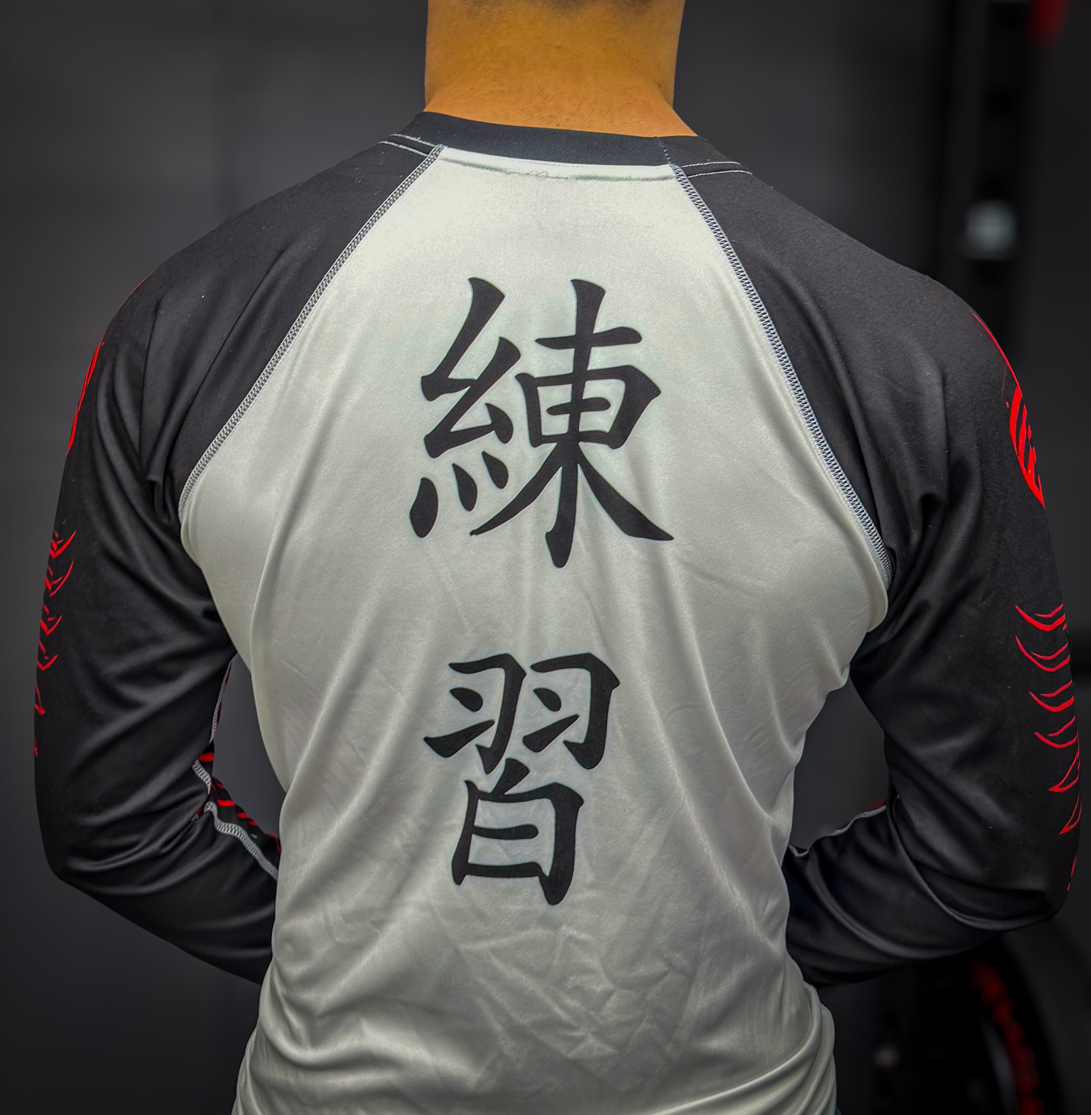 Person wearing a sports jersey with black text on the back against a dark background