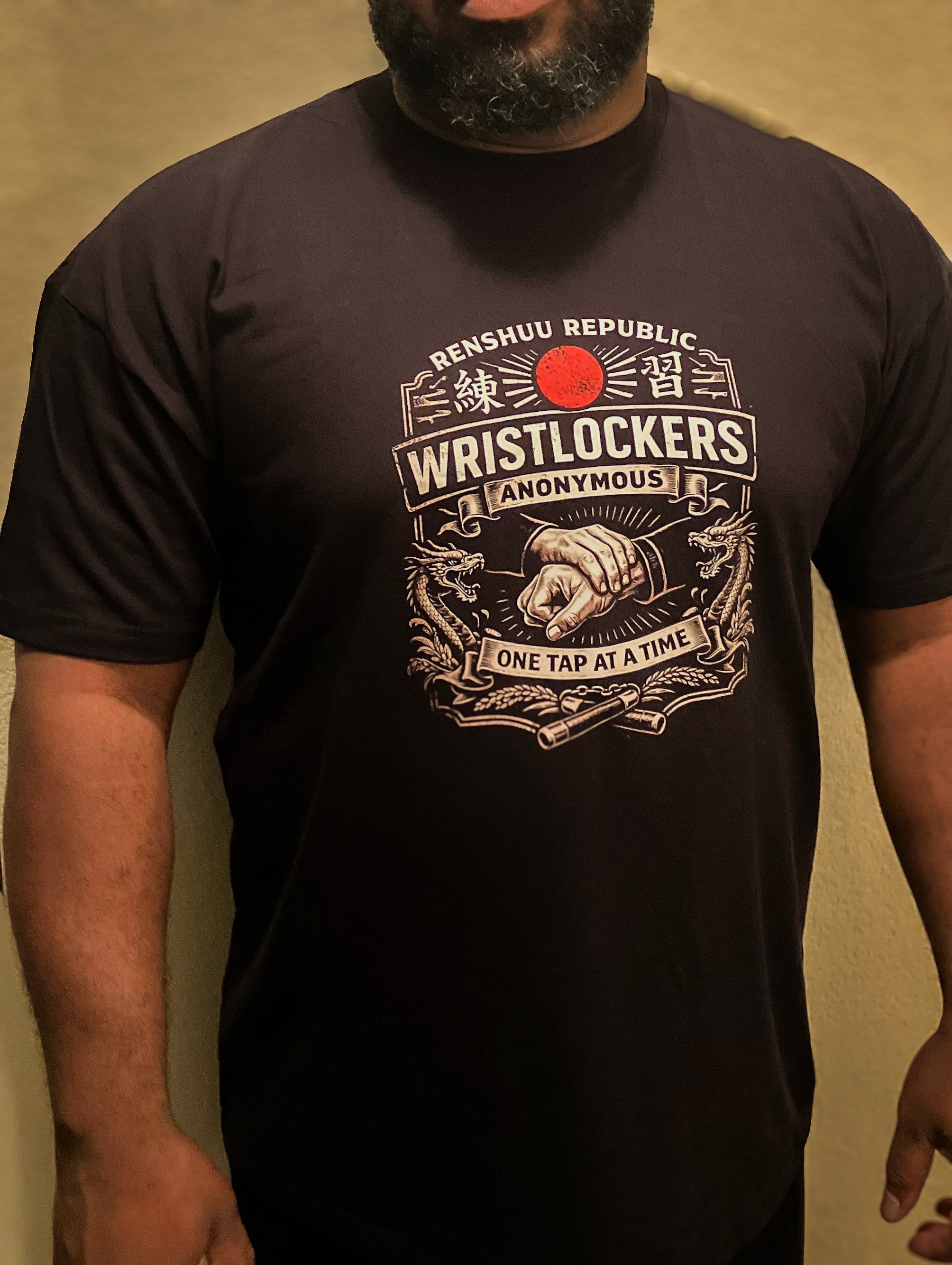 Person wearing a black t-shirt with a graphic design and text.
